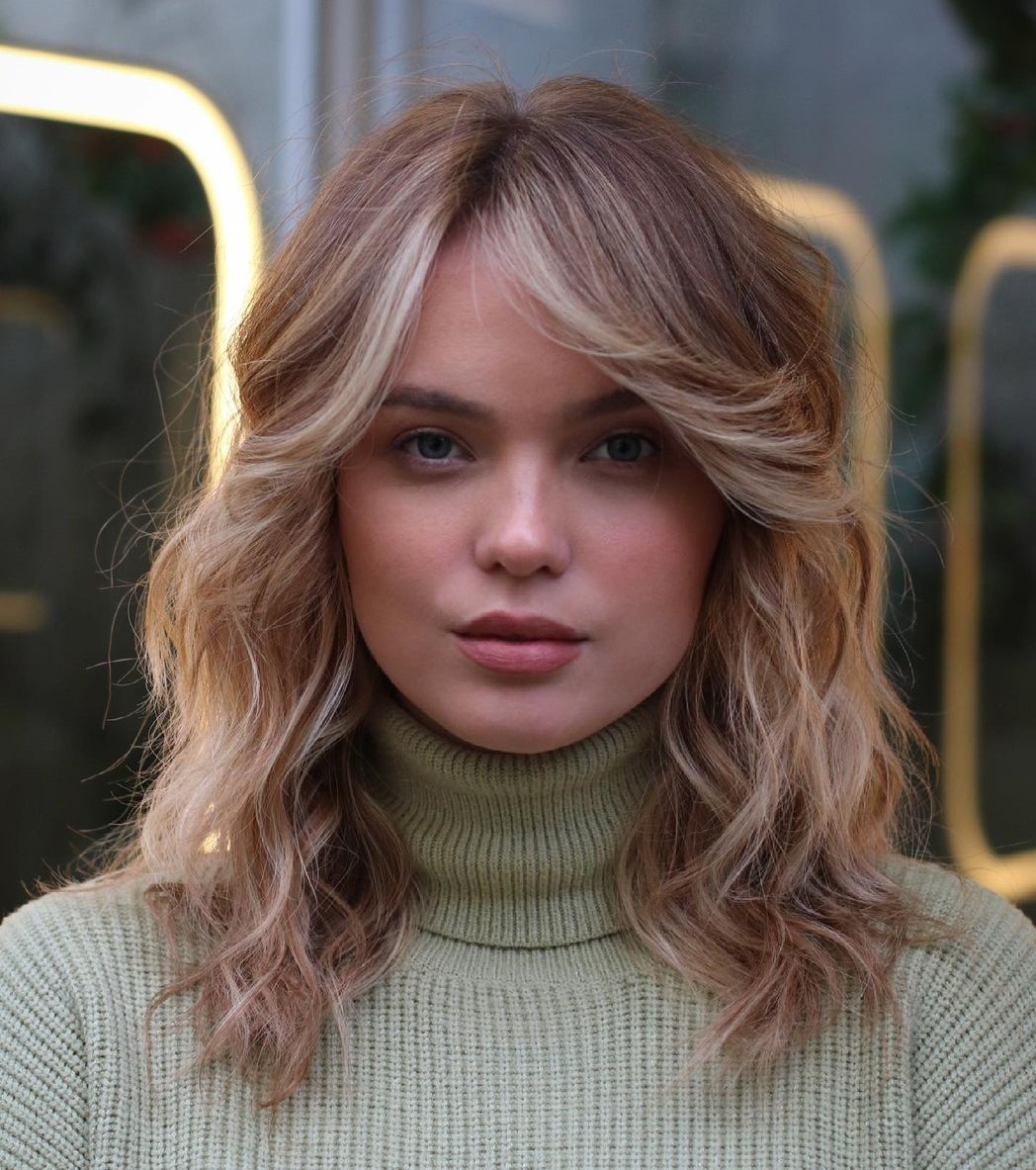 Medium Wavy Hairstyle with Flipped-Up Bangs